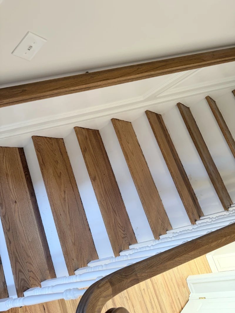 Stair treads sanded back to bare oak against freshly painted white risers